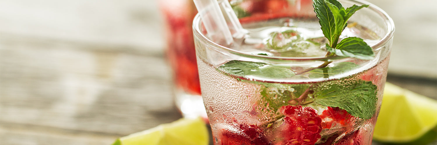Tasty cold fresh drink lemonade with raspberry, mint, ice and li